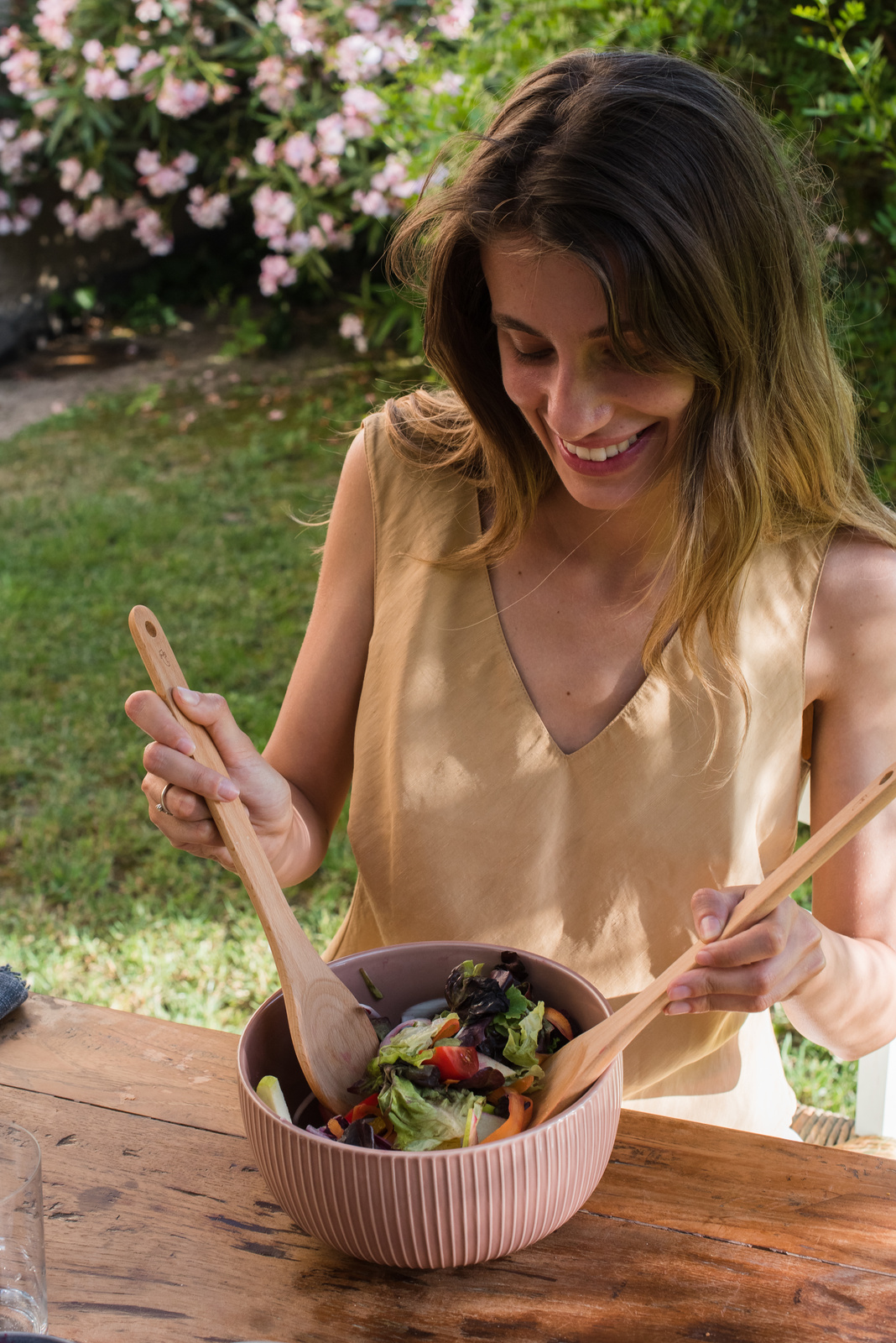 Happy Woman Mixing Vegetable Salad in a Bowl