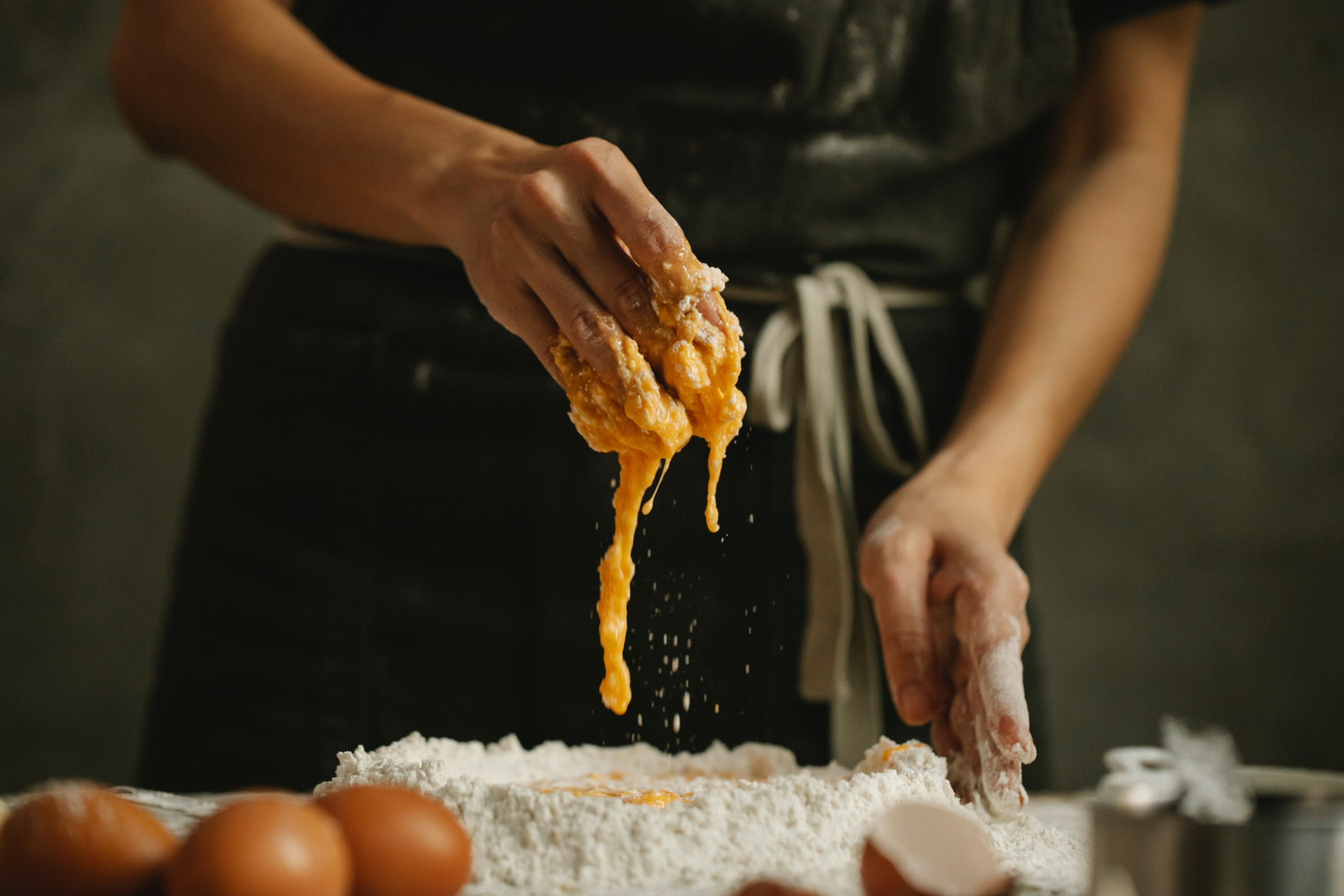 Woman making homemade dough in kitchen