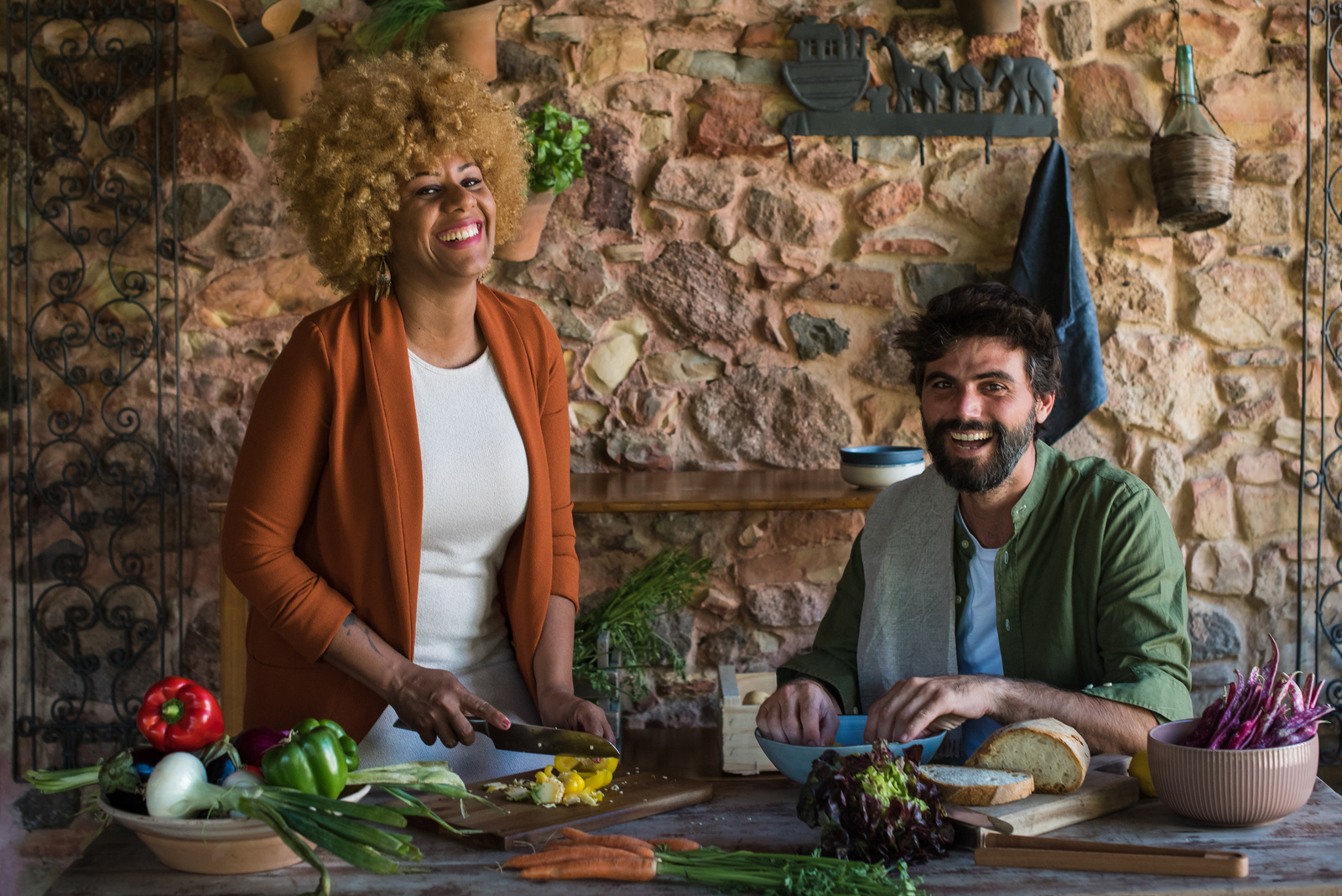 Happy Man and Woman Cooking Vegetables in the Kitchen